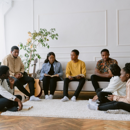 A small group sitting together with open Bibles
